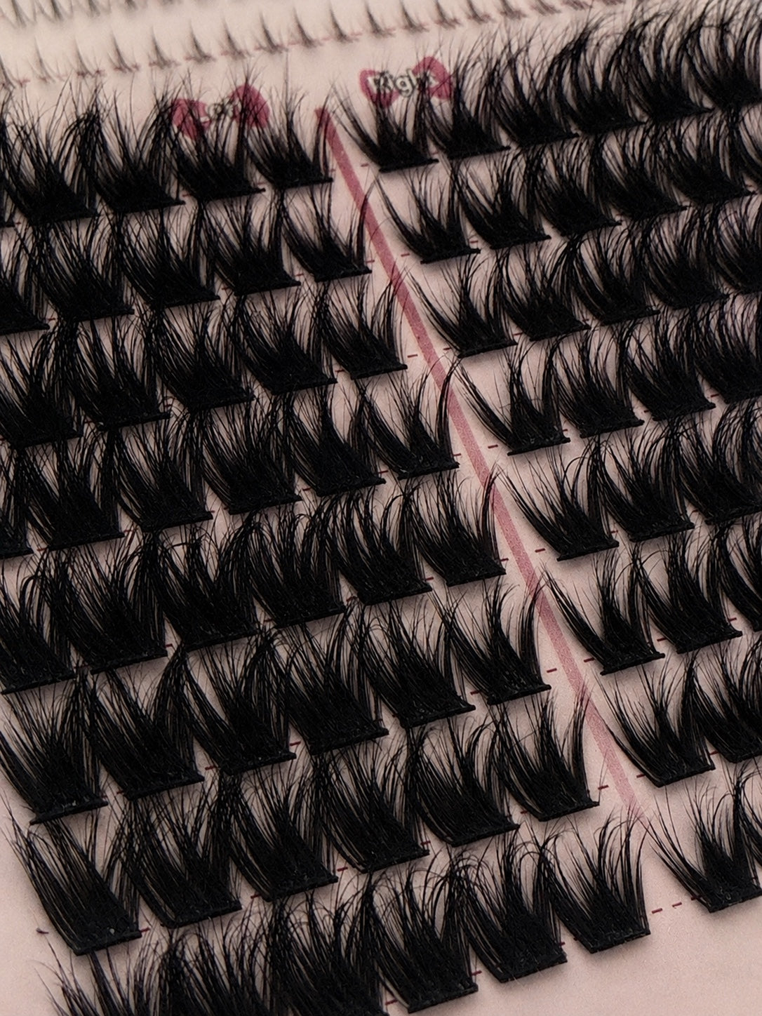 Detailed close-up of DIY lash clusters arranged in the lash tray